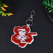 Red acrylic hibiscus flower keychain featuring custom white overlay script name Nikky with silver lobster clasp hardware.