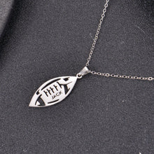Close-up of engraved football pendant showing personalized name