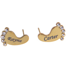 Gold baby feet stud earrings styled as personalized jewelry for a new mom.