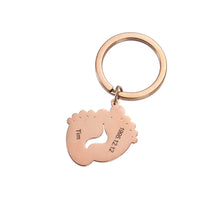 Rose gold personalized baby footprint keychain engraved with a baby's name and special date.
