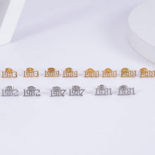 personalized number earrings in gold and silver displayed