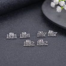 Close-up of a personalized Old English number charm anklet showing the custom engraved year.