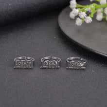 Silver personalized birth year ring with custom Old English number lettering.