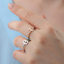 Woman wearing personalized initial birthstone ring