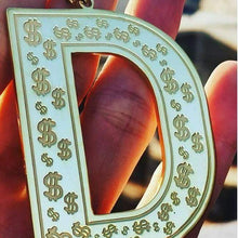 Close-up of engraved border detail on large letter pendant