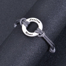 Custom washer charm silver bracelet on jewelry display