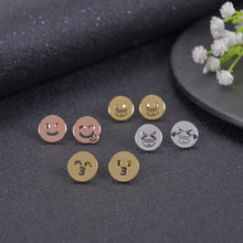 Gold, silver, and rose gold emoji earrings shown together