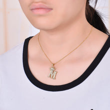 Crown initial necklace worn around the neck