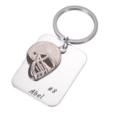 Personalized football keychain displayed as a sports gift for a football player, coach, dad, or fan.