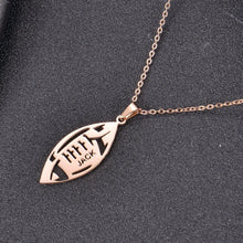 Football pendant necklace styled as a sports keepsake