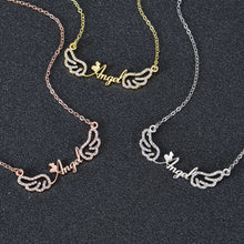 Custom angel wing necklace laid flat on dark background
