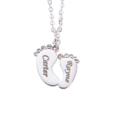 Silver personalized baby footprint necklace with engraved baby name pendant.