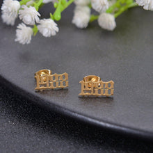 Gold personalized birth year earrings featuring a custom year engraved in Old English font.