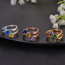 Silver, rose gold, and gold birthstone rings shown together