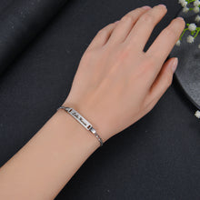 A Person Wearing A Silver Bar Name Bracelet