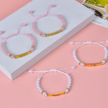 Custom pearl beaded bracelet featuring engraved gold bar and adjustable white woven cord.