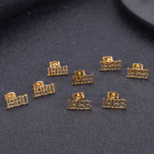 A set of eight gold-toned stud earrings featuring different years