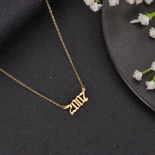 Gold custom year necklace styled as a personalized birthday or milestone gift for her.