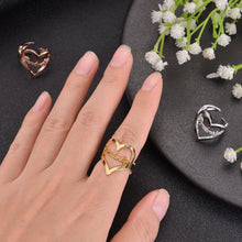 Hand wearing gold customized heart name ring for scale and style perspective.