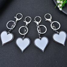 Four silver keychains with blank white heart-shaped charms. Each keychain has a silver split ring and a silver lobster clasp.