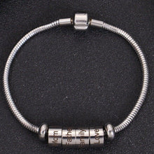 Silver custom snake chain bracelet featuring engraved cylinder beads with family terms Mom, Father, Family, and Love.
