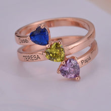 Close-up of stacked ring bands with heart gemstones