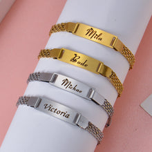 Grouping of gold and silver double strand nameplate bracelets showing metallic luster and chain construction details.