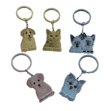 Pet portrait keychains shown in silver gold and rose gold with custom engraved pet designs