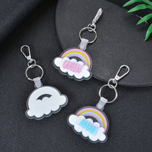 Pendantify personalized rainbow keychain featuring pastel cloud acrylic silhouetted with custom glitter block lettering in purple, pink, and blue.