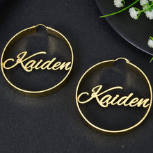 Gold custom round hoop earrings with script nameplate Kaiden spanning across the center of the wire frame.