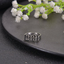Close-up of a personalized Old English year ring showing the custom number design.