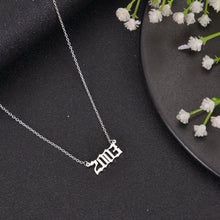 Silver personalized birth year necklace with Old English number pendant on a delicate chain.