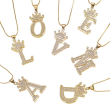 A set of gold necklaces with letter pendants and crowns. Each pendant is encrusted with clear rhinestones. The letters are L, O, V, E, M, A, and D.