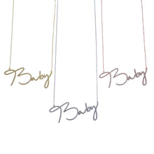 Gold, silver, and rose gold cursive necklaces shown together