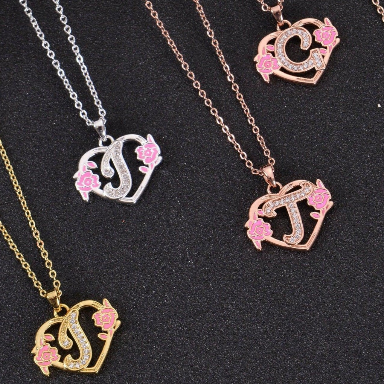 Custom heart initial necklace laid flat on jewelry display