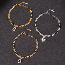 Gold, silver, and rose gold initial bracelets shown together