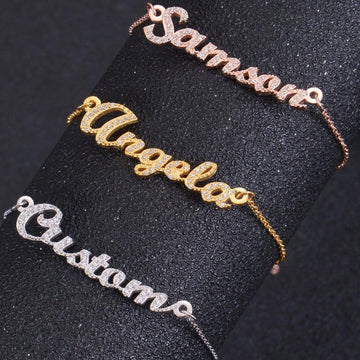 Close-up of sparkling cubic zirconia name plate on bracelet
