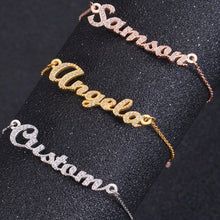 Close-up of sparkling cubic zirconia name plate on bracelet