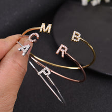Initial bangle bracelets spelling out different letters