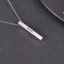 Silver personalized four sided bar necklace featuring custom engraved names on a vertical pendant.