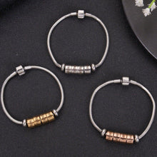 Trio of silver, gold, and rose gold custom family bead snake chain bracelets displayed on dark textured background.