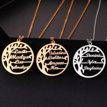 Close-up of a personalized family tree pendant showing multiple engraved names among the tree branches.