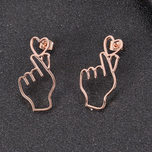 Rose gold finger heart earrings featuring a Korean love gesture