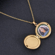 Open gold circle-shaped locket displaying custom inserted portrait photograph on delicate chain.