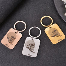 Custom football helmet keychains with personalized names and numbers displayed together as team gifts.
