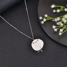 Silver meme pendant necklace with humorous face engraving