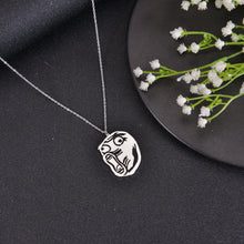 Silver meme pendant necklace with humorous face engraving