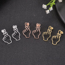 Silver, rose gold, and gold Korean finger heart earrings displayed together