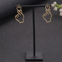 Minimalist finger heart earrings styled as a cute gift for her
