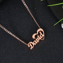 Rose gold personalized nameplate necklace featuring script name David connecting directly to a open heart frame.